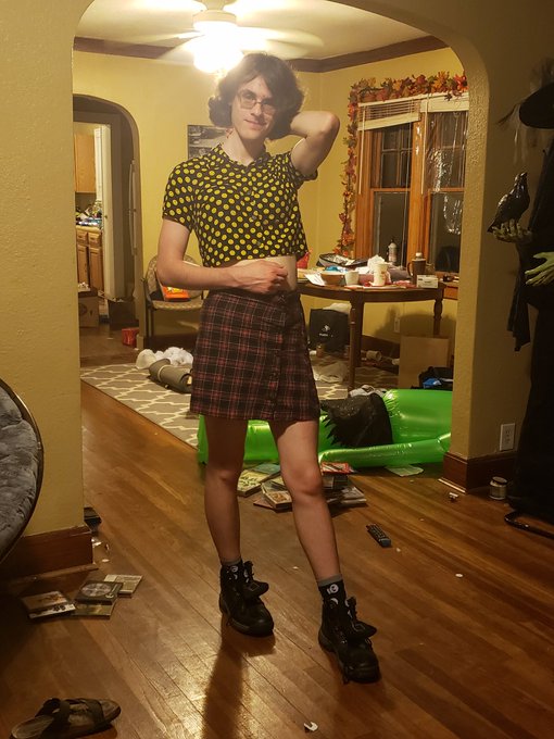 black button-up crop top with smiley faces on it but ur so far away they just look like yellow polka dots. a tight red/black plaid skirt, socks with skulls, black hiking boots